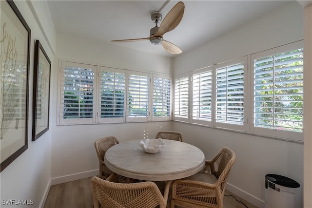 dining room with ceiling fan and wood-type flooring