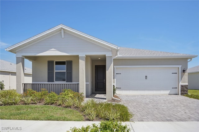 44284 Frontier Dr, Punta Gorda, FL 33982 - ranch-style home with decorative driveway, a porch, an attached garage, and stucco siding