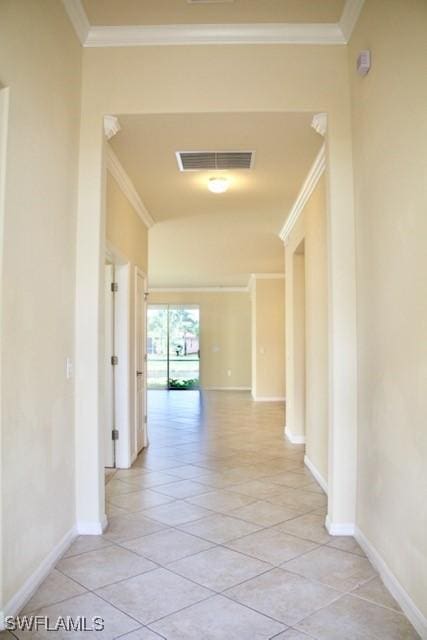 hall featuring ornamental molding and light tile patterned floors