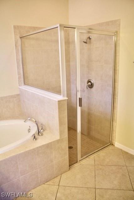 bathroom featuring tile patterned flooring and plus walk in shower