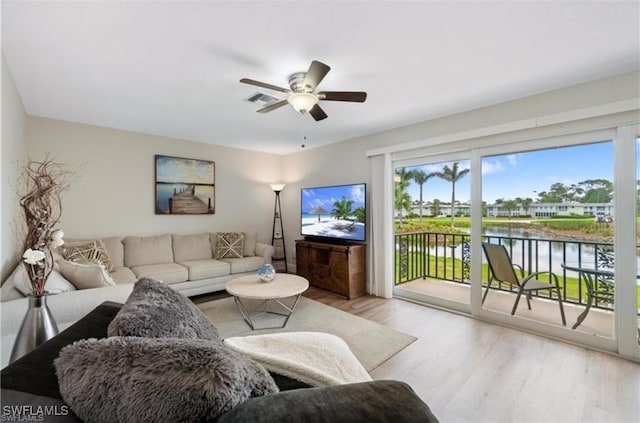 living room with ceiling fan and light hardwood / wood-style floors