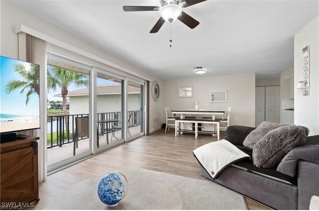 living room with ceiling fan and light hardwood / wood-style floors