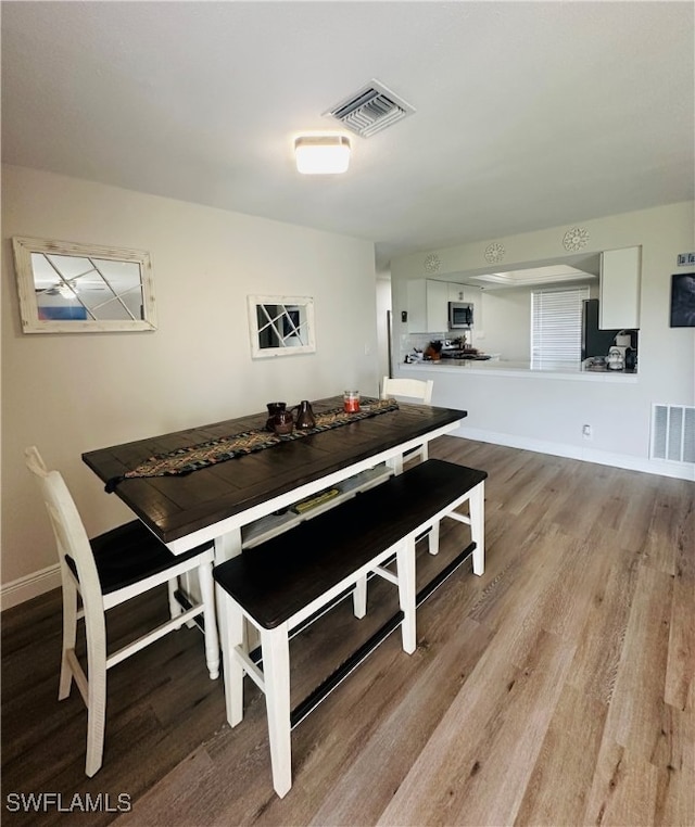 dining area with light hardwood / wood-style flooring