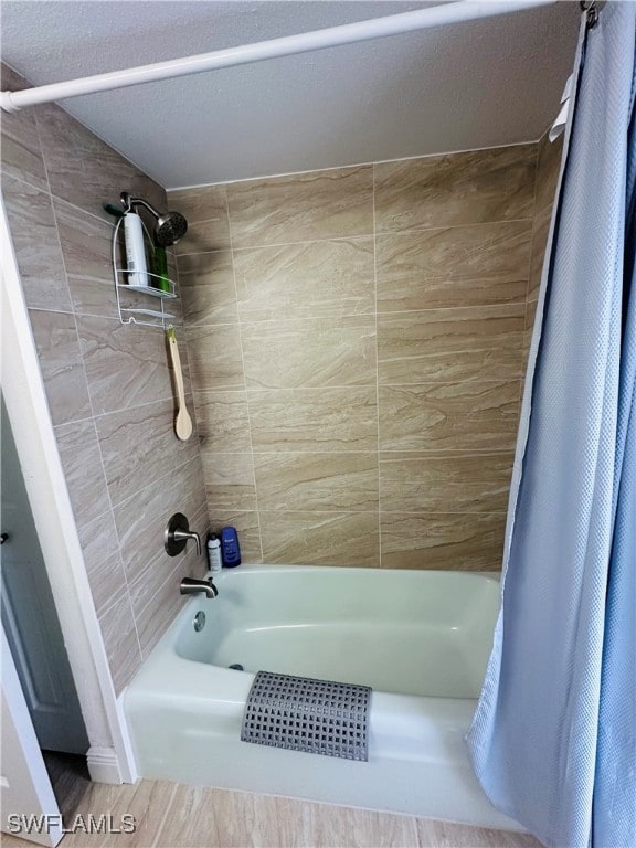 bathroom featuring shower / bathtub combination with curtain