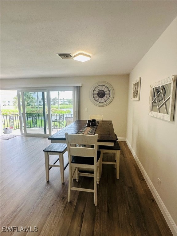 dining room with dark hardwood / wood-style floors