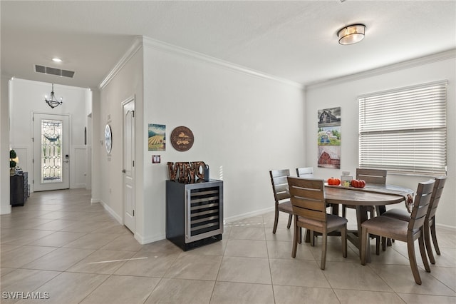 tiled dining room featuring wine cooler, a notable chandelier, and crown molding