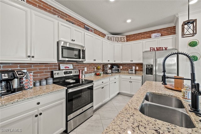 kitchen featuring sink, crown molding, hanging light fixtures, stainless steel appliances, and white cabinets