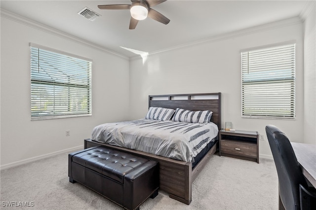 carpeted bedroom featuring crown molding and ceiling fan