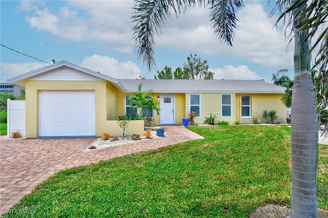 single story home featuring a front yard and a garage