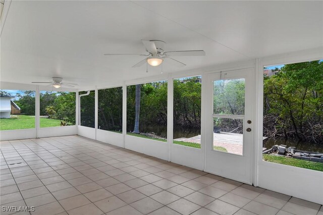 unfurnished sunroom featuring ceiling fan