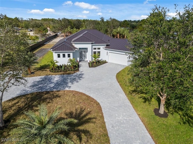 view of front of house featuring a garage and a front lawn