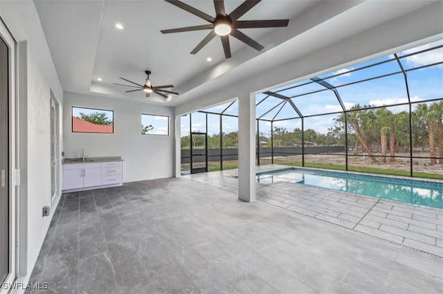 view of swimming pool with glass enclosure and a patio area