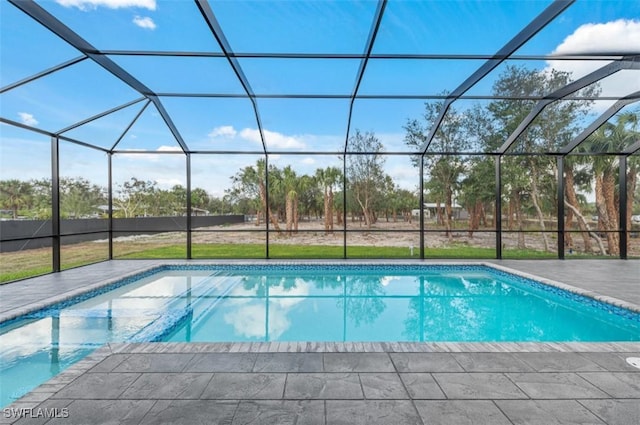 view of swimming pool featuring a lanai and a patio