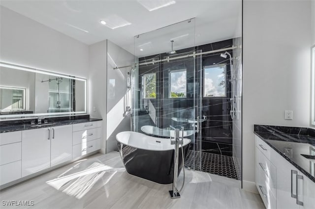 bathroom featuring vanity, wood-type flooring, and independent shower and bath