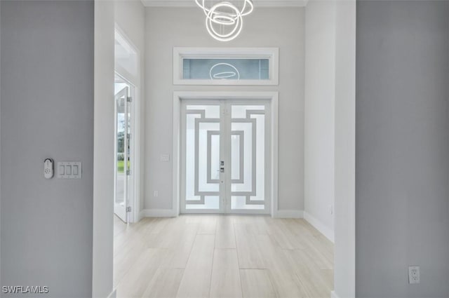 foyer featuring a chandelier and light hardwood / wood-style floors