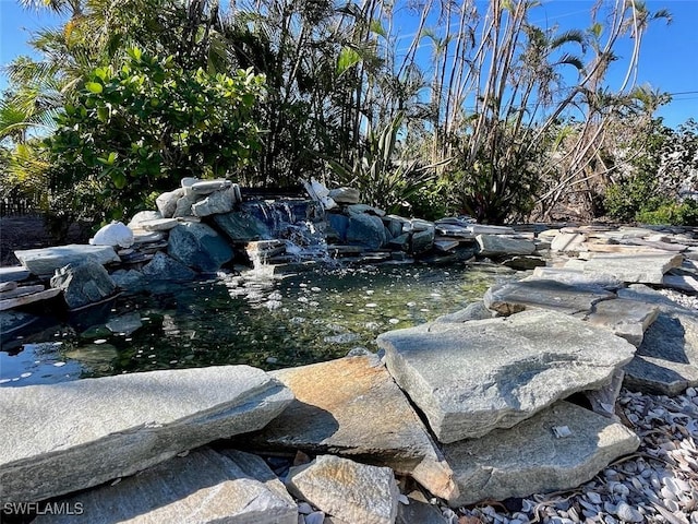 exterior space featuring a small pond