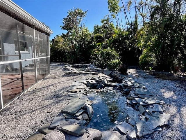 view of yard with a sunroom