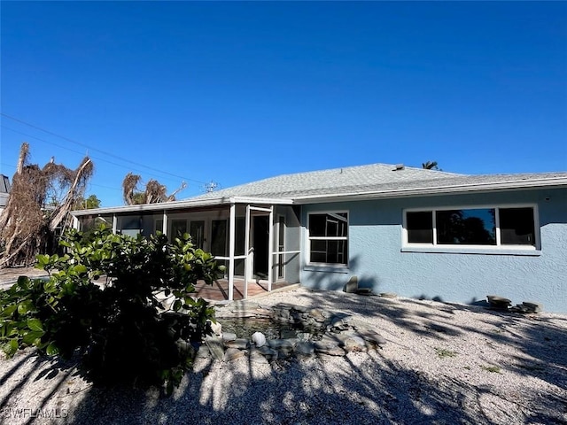 back of house with a sunroom