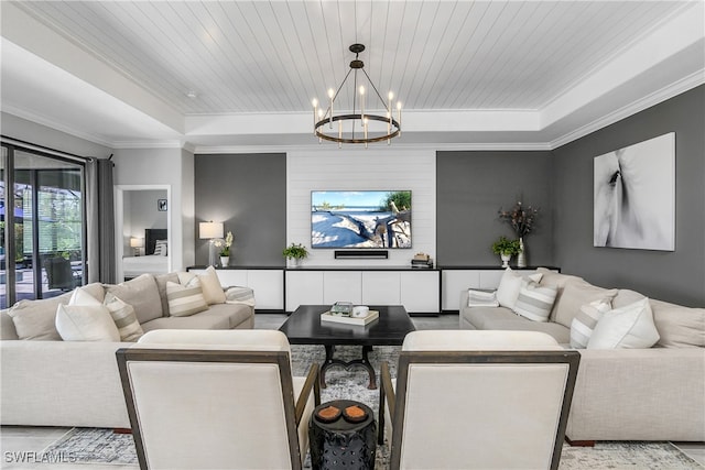 living room featuring a tray ceiling, an inviting chandelier, ornamental molding, and wood ceiling