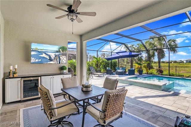 view of patio featuring area for grilling, beverage cooler, a lanai, and ceiling fan