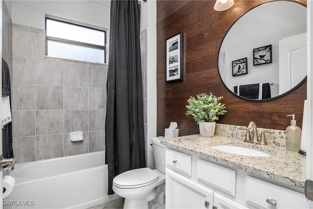 full bathroom with toilet, vanity, shower / tub combo with curtain, and wood walls