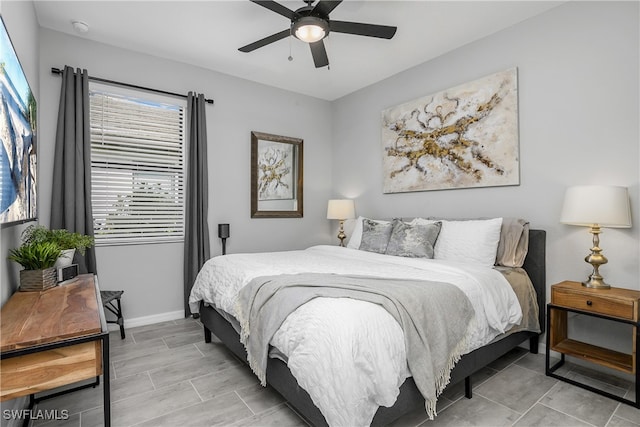 bedroom with baseboards and ceiling fan