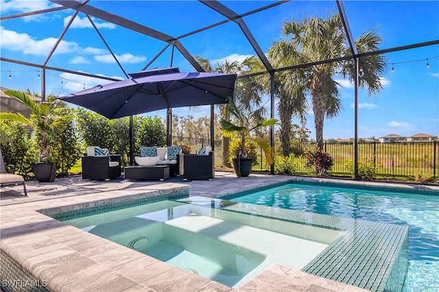 view of pool featuring an in ground hot tub, a patio, glass enclosure, and an outdoor hangout area