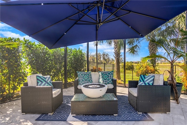 view of patio / terrace with an outdoor hangout area and fence