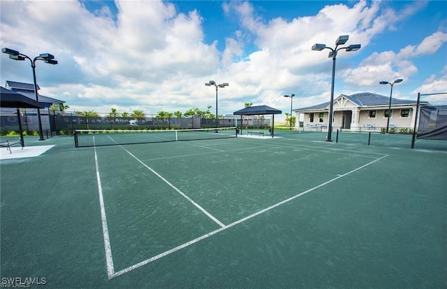 view of sport court featuring fence