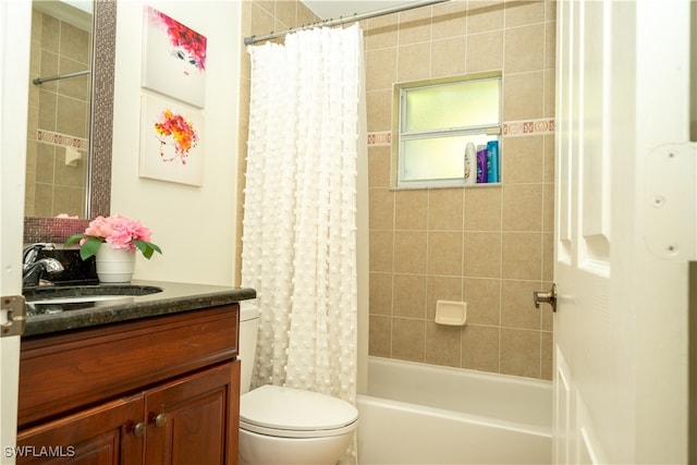 full bathroom with toilet, vanity, and shower / tub combo