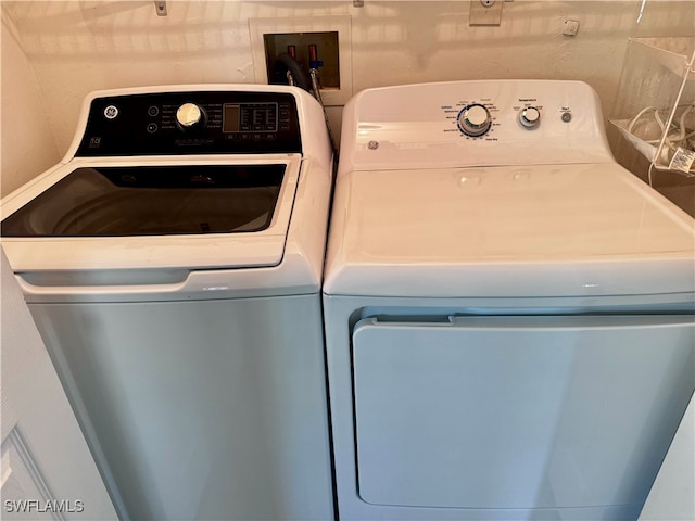 clothes washing area featuring independent washer and dryer