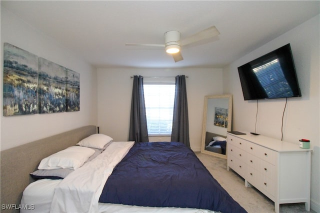 bedroom featuring light carpet and ceiling fan