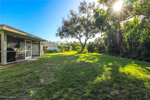 view of yard featuring a sunroom