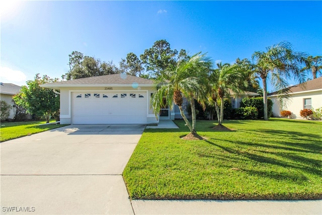 view of front of home with a front lawn and a garage