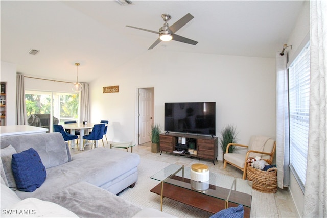 living room featuring ceiling fan, vaulted ceiling, and a wealth of natural light