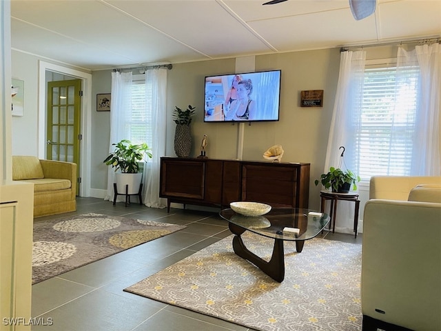 tiled living room featuring ceiling fan