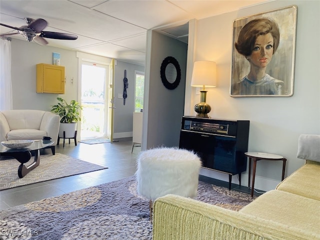 tiled living room featuring ceiling fan