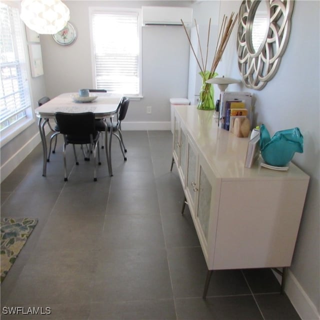 tiled dining area with an AC wall unit and a wealth of natural light