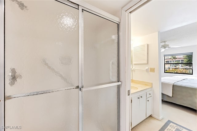 bathroom with vanity, ceiling fan, and an enclosed shower