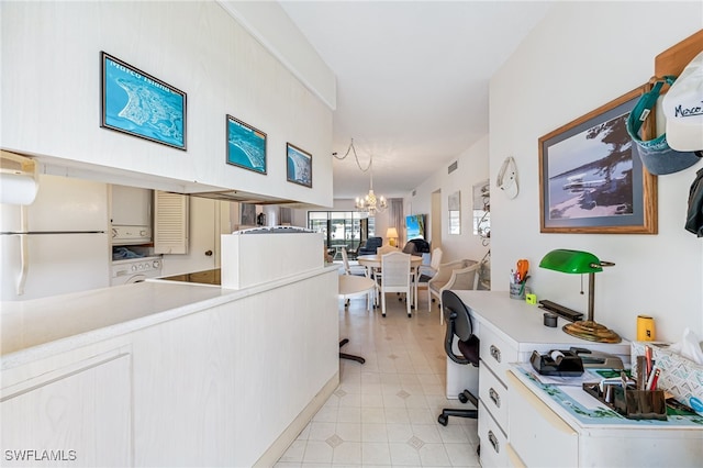 interior space with stacked washing maching and dryer and a chandelier