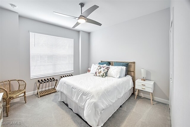 bedroom with ceiling fan and light colored carpet