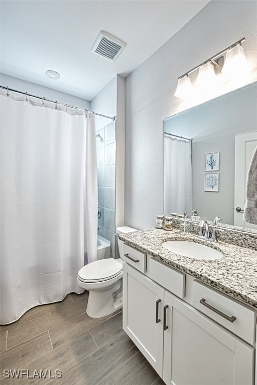 full bathroom featuring toilet, vanity, and shower / bath combo with shower curtain