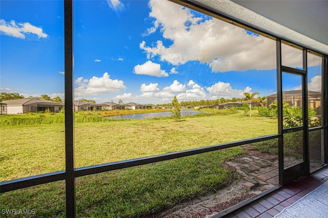 unfurnished sunroom with a wealth of natural light and a water view