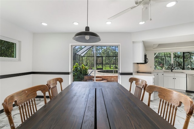 dining space with ceiling fan, sink, and plenty of natural light