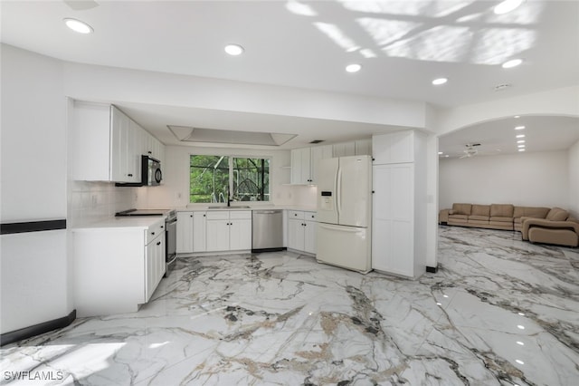 kitchen with white cabinetry, stainless steel appliances, sink, and ceiling fan