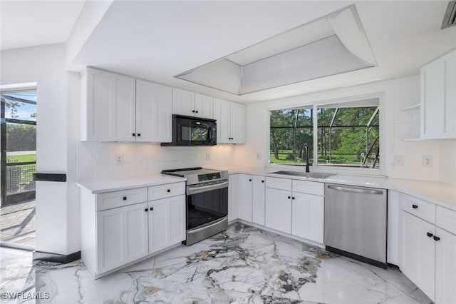 kitchen with white cabinets, stainless steel appliances, sink, and plenty of natural light