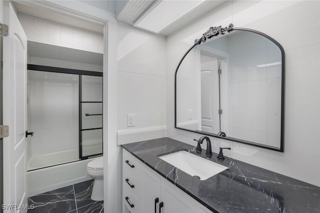 full bathroom with vanity, toilet, and enclosed tub / shower combo