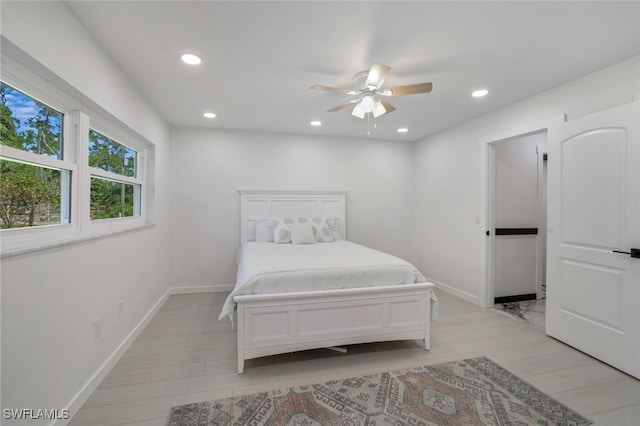 bedroom with ceiling fan and light wood-type flooring