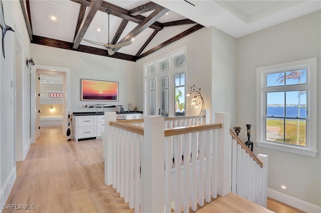 stairs featuring wooden ceiling, beam ceiling, wood-type flooring, and high vaulted ceiling