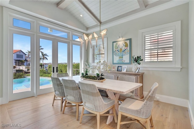 dining area featuring vaulted ceiling with beams, light hardwood / wood-style flooring, and french doors